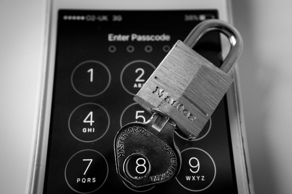 Padlock with key and smartphone